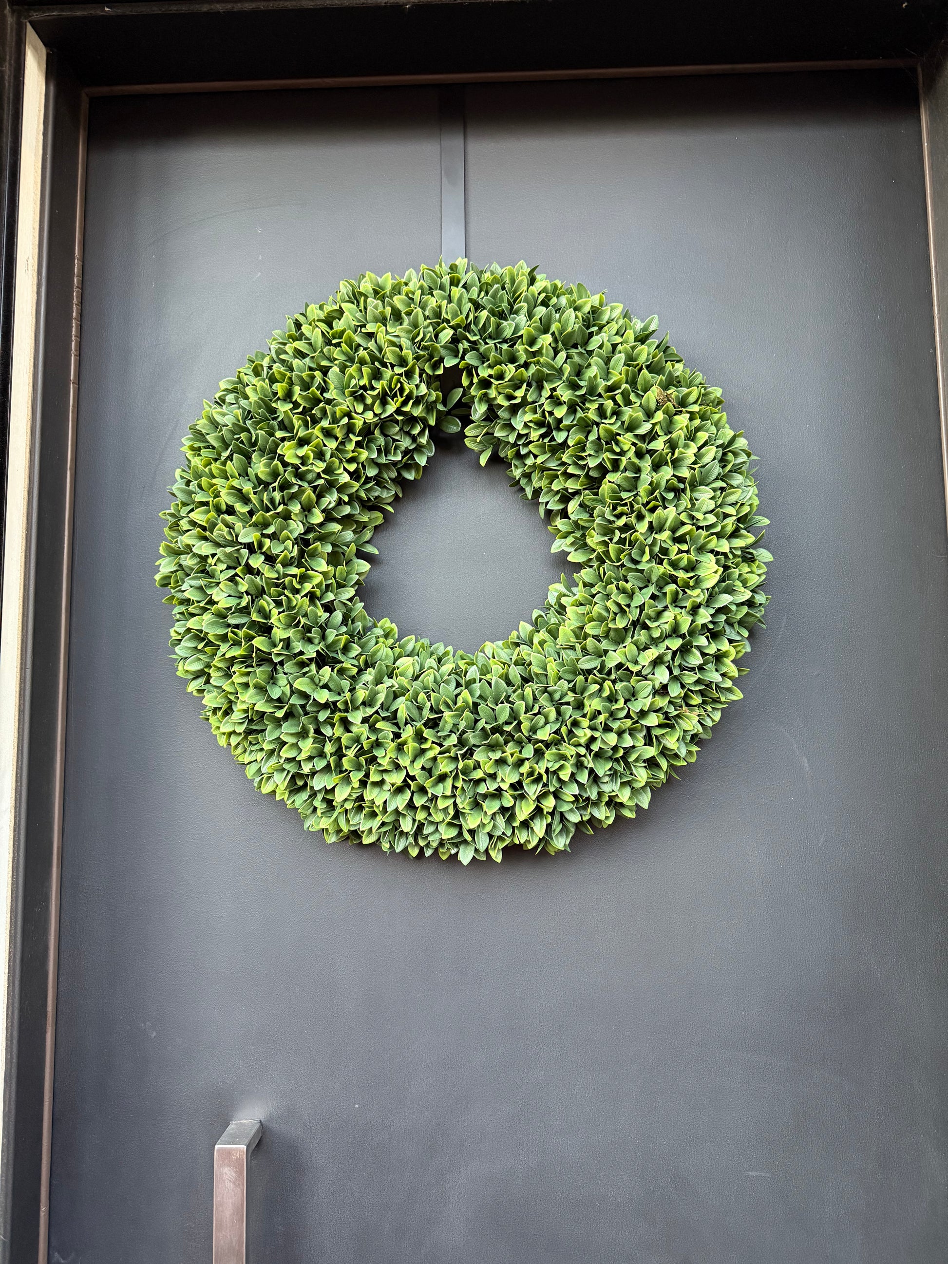 Boxwood wreath on a dark gray surface