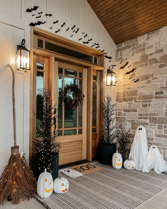 A Halloween themed porch decoration set including pumpkins, ghosts, bats, and a seasonal wreath.